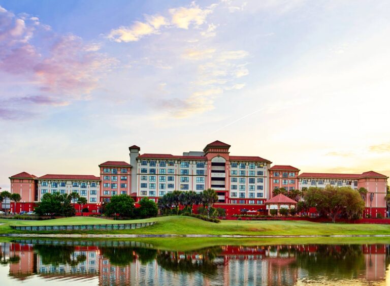 FPAT: Premier Reserve Study Services for Florida Condos Overlooking Golf Courses – Ensuring Compliance and Peace of Mind. - FPAT Luxurious Florida condo overlooking a vibrant golf course at sunset, illustrating FPAT's expertise as the top reserve study provider helping condo boards with financial planning and hurricane preparedness.