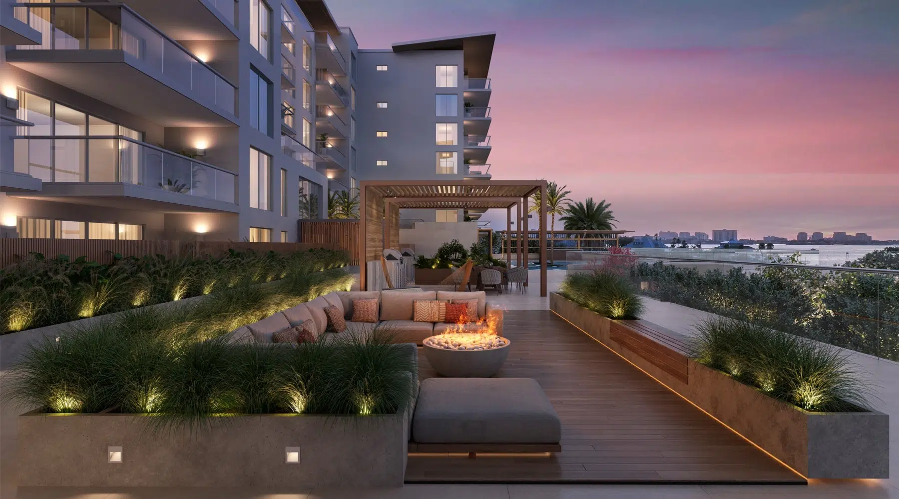Aerial photograph of a multi-story pink condominium building with orange tile roof, balconies, and marina view in Clearwater Beach, Florida, exemplifying properties needing realistic reserve studies to handle coastal weather and regulations.