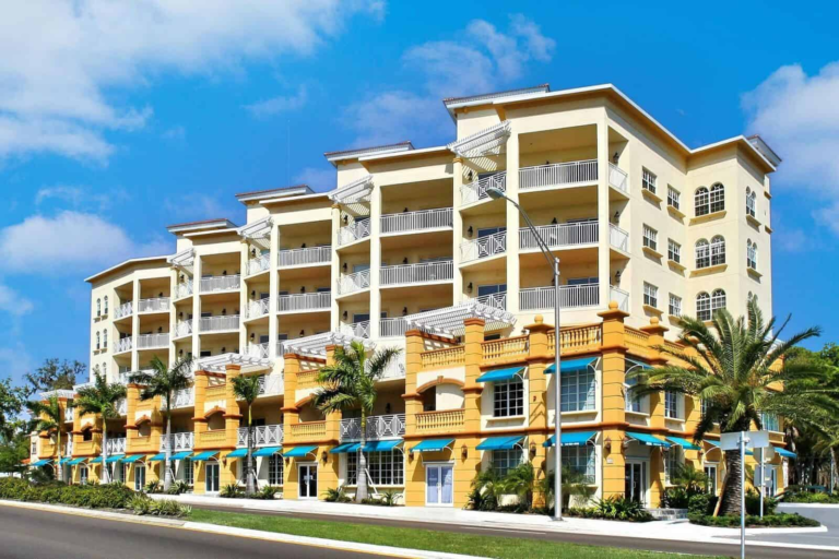 san-marco-condos-downtown-sarasota-fl-1 - FPAT - FPAT Professional Sarasota Condo Exterior for Florida Insurance Appraisal Services Mediterranean Coastal Condo with Balconies Palms and Stucco Architecture